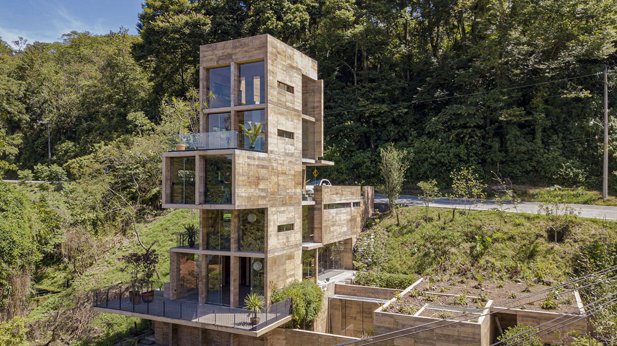 Earth-toned apartment building prioritizes views towards a forest in Coatepec, Mexico