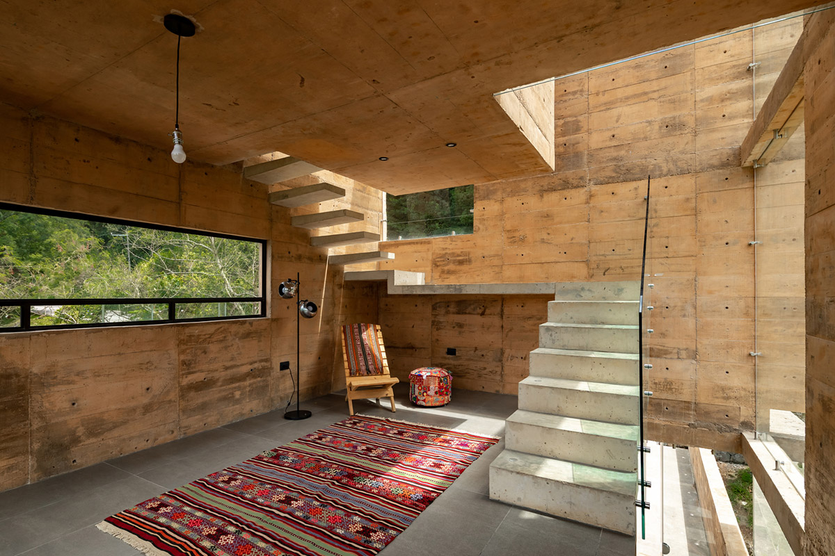 Earth-toned apartment building prioritizes views towards a forest in Coatepec, Mexico