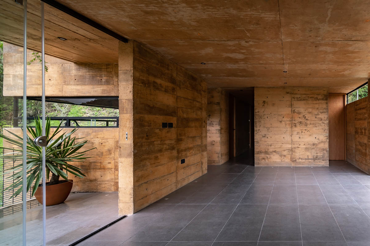 Earth-toned apartment building prioritizes views towards a forest in Coatepec, Mexico