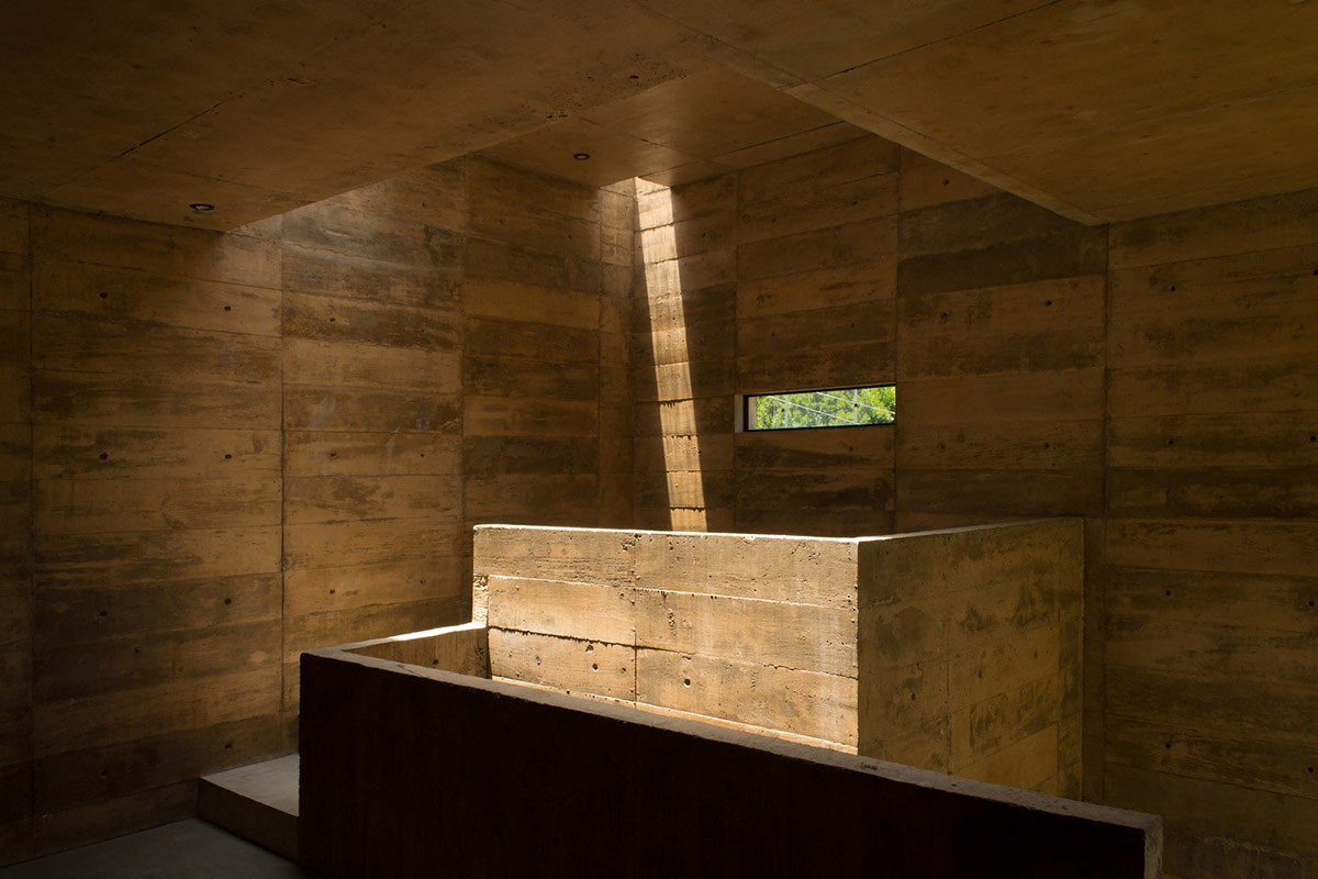 Earth-toned apartment building prioritizes views towards a forest in Coatepec, Mexico