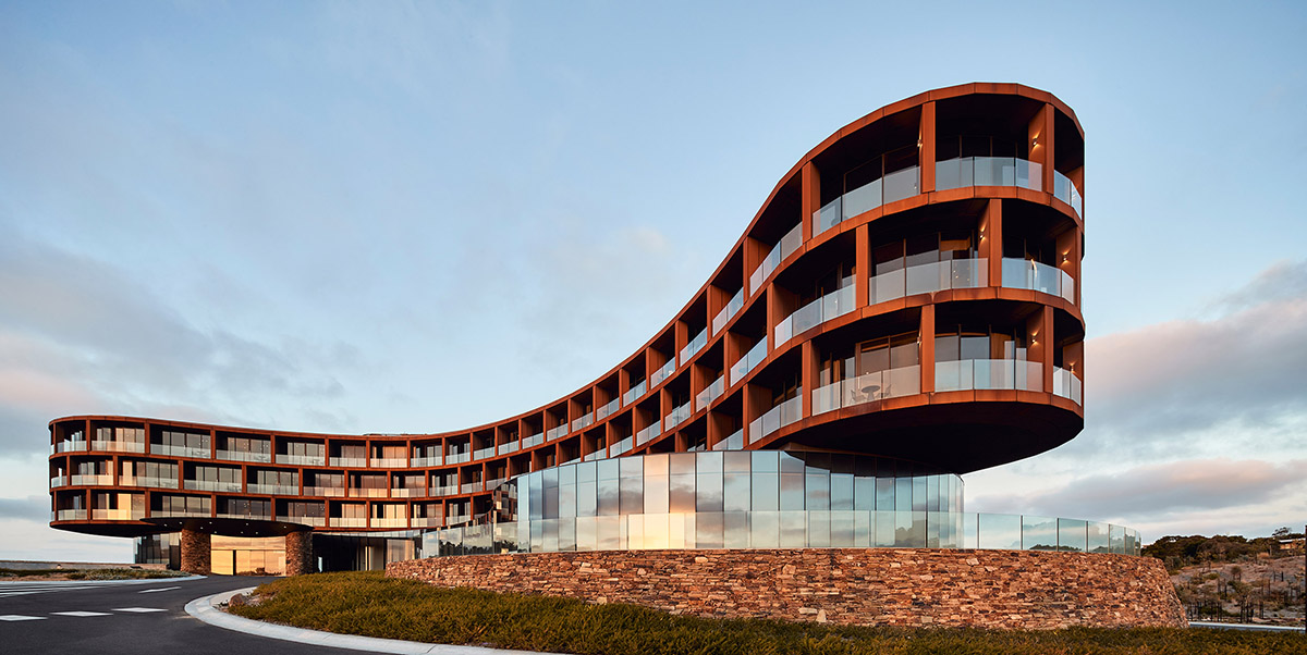 Wood Marsh completes sinuous resort anchored on hand-built locally sourced stone plinth in Australia
