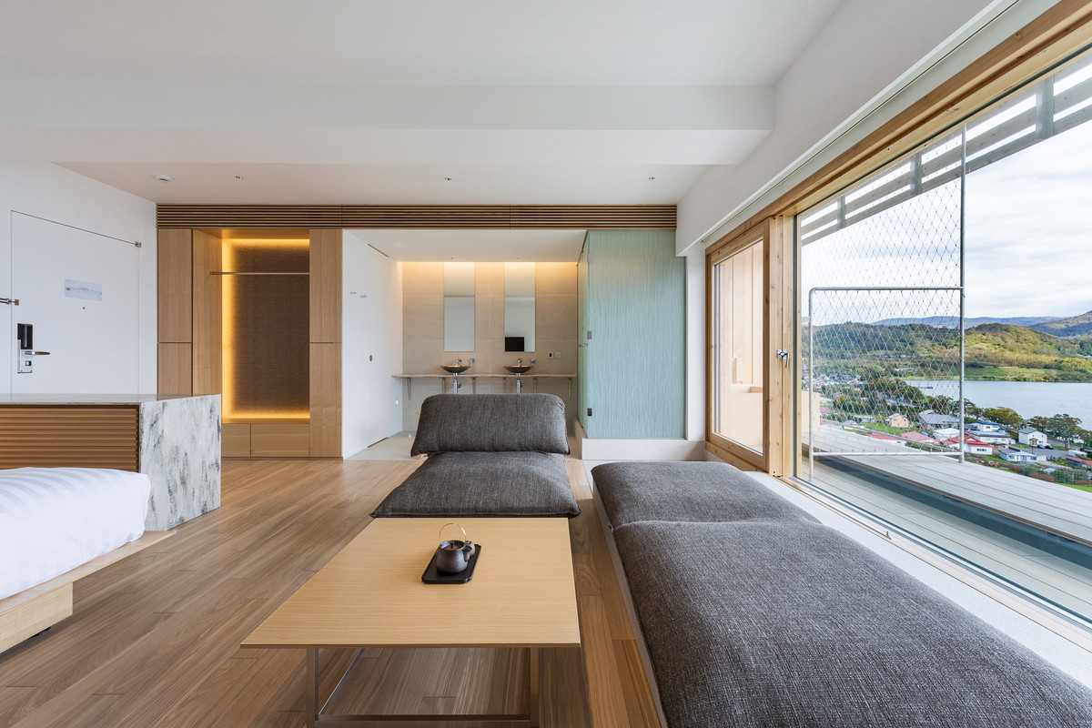 Kengo Kuma completes We Hotel Toya with cave-like interior on the shore of Lake Toya in Japan