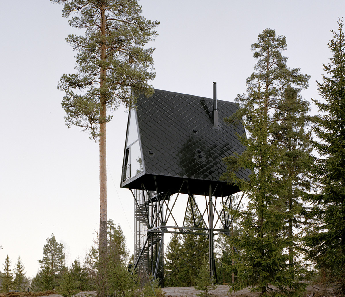Espen Surnevik uses simple geometry for cabins raised on slim columns in forest area of Norway