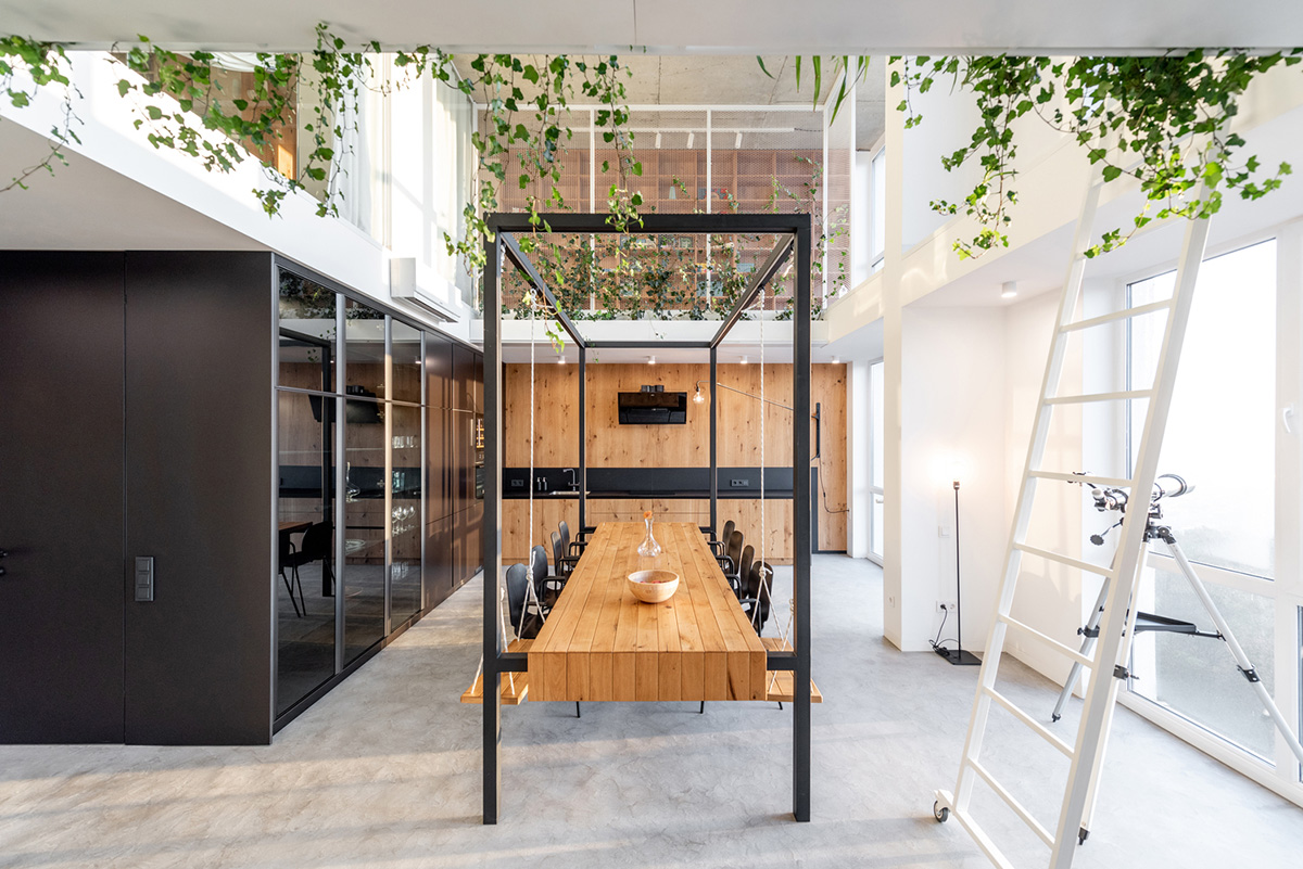 Metal framed-table, glass partitions, green infills make this interior space vivid and light in Lviv
