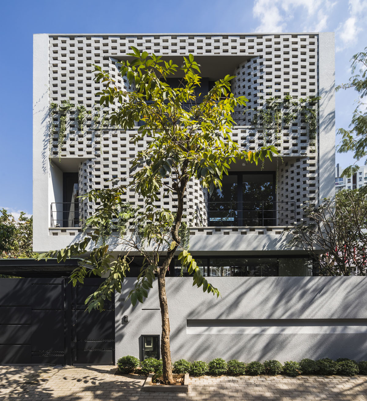 Nha Dan Architects built this house with porous facade to provide maximum thermal comfort in Vietnam