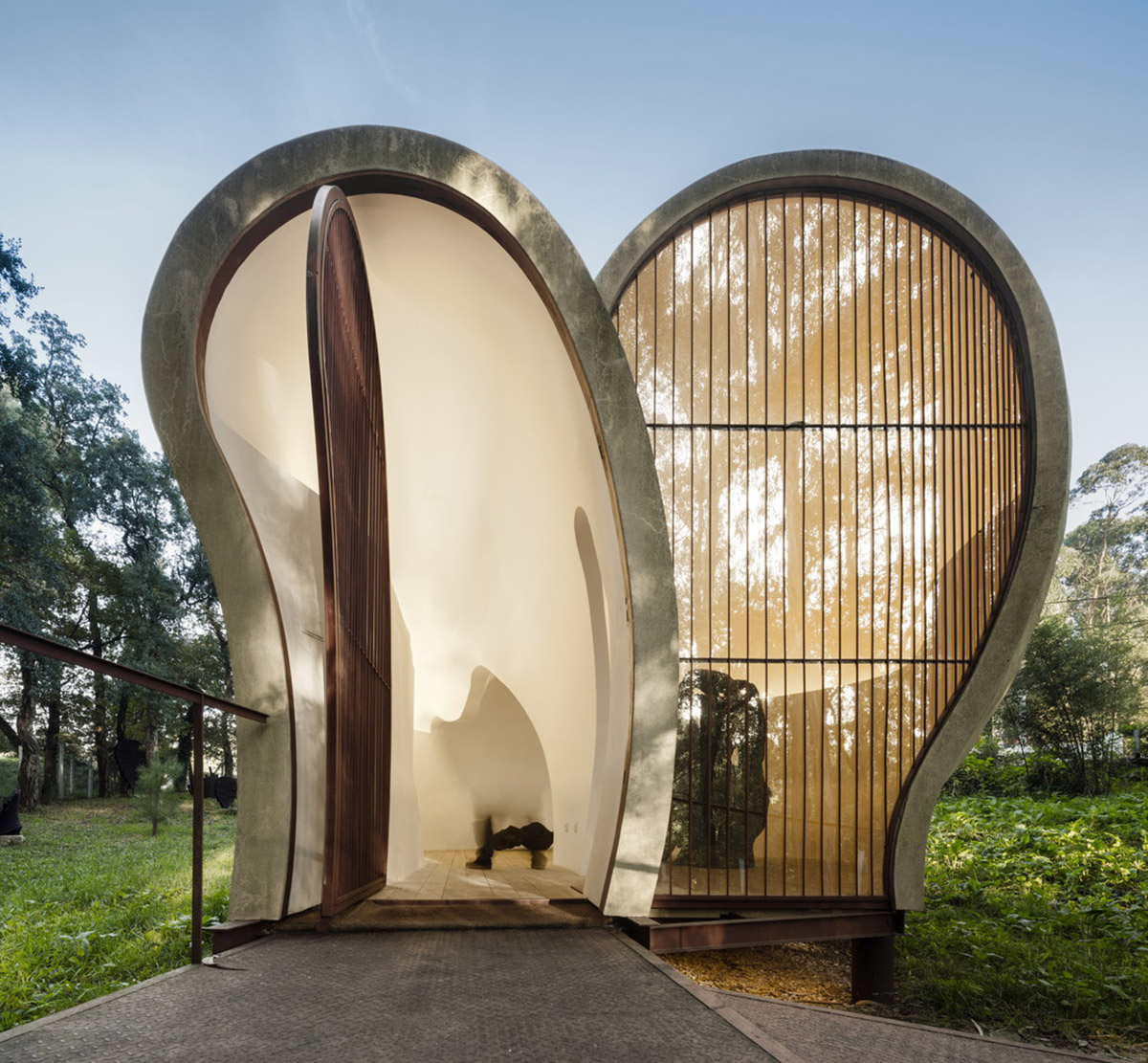 Super small cave-like art gallery by FCC Arquitectura built on lush green in Portugal