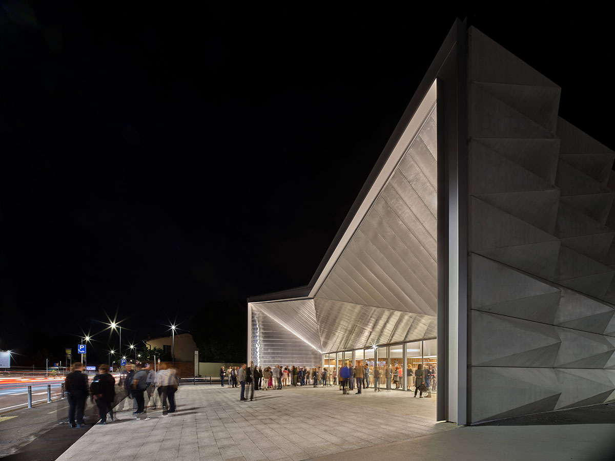 Teatro Borsoni theater is wrapped by façades that feature 3D-punctuated concrete blocks in Italy
