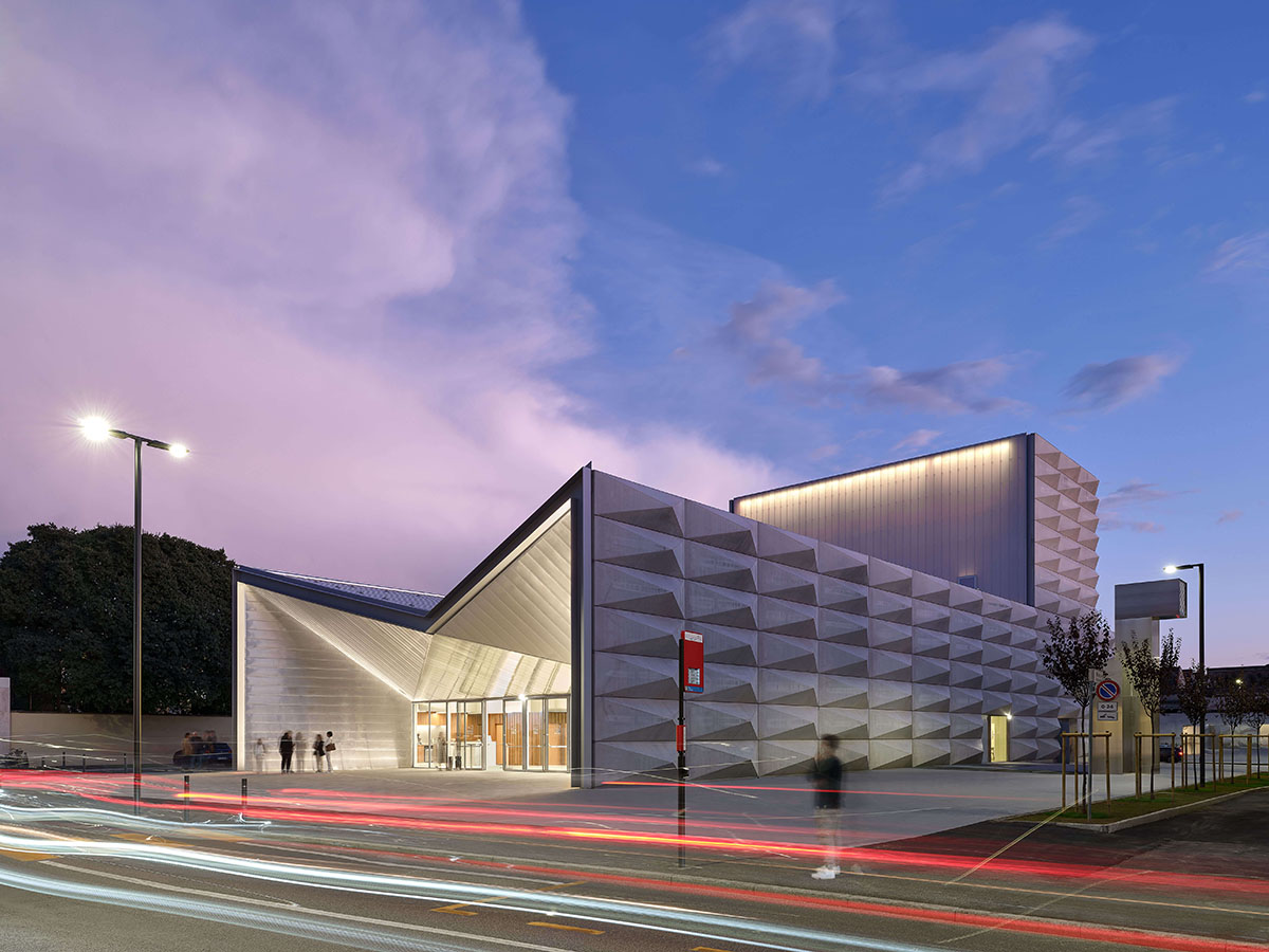 Teatro Borsoni theater is wrapped by façades that feature 3D-punctuated concrete blocks in Italy