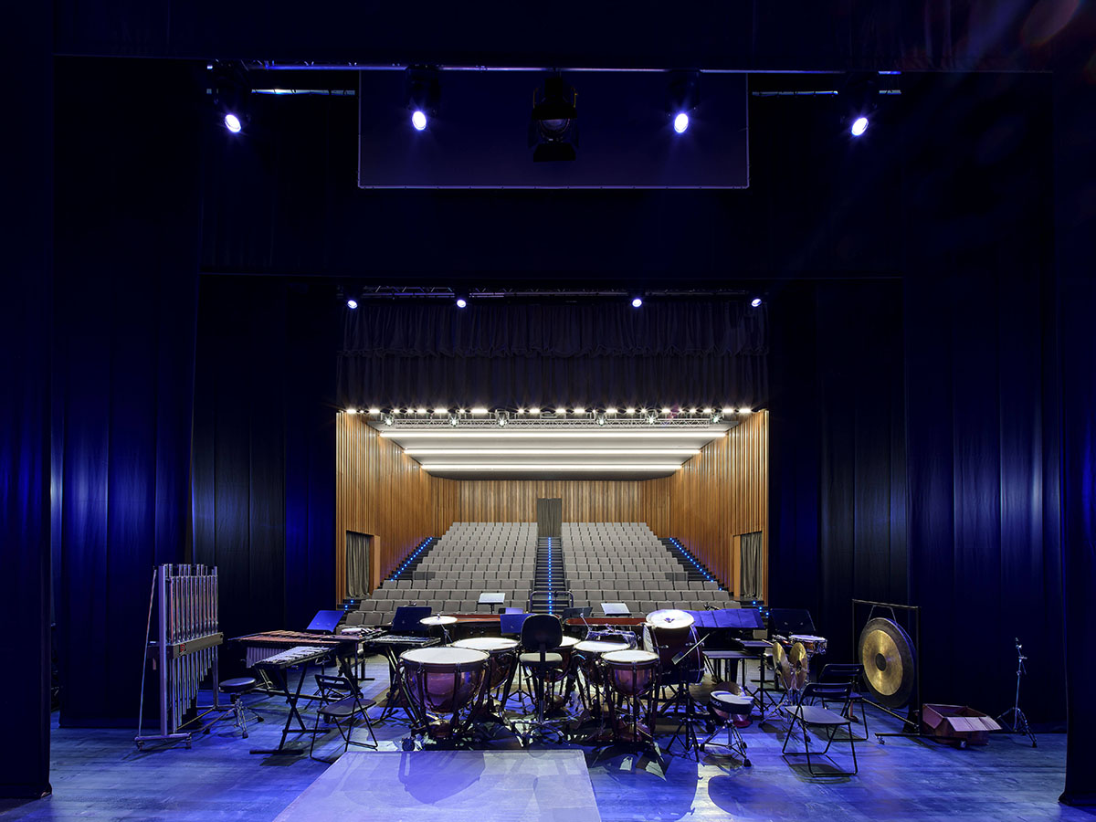 Teatro Borsoni theater is wrapped by façades that feature 3D-punctuated concrete blocks in Italy