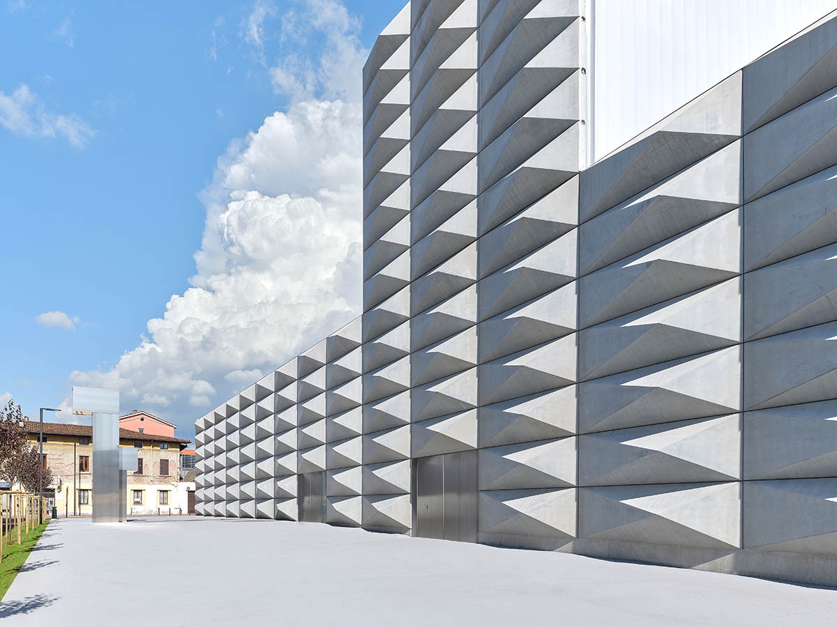 Teatro Borsoni theater is wrapped by façades that feature 3D-punctuated concrete blocks in Italy