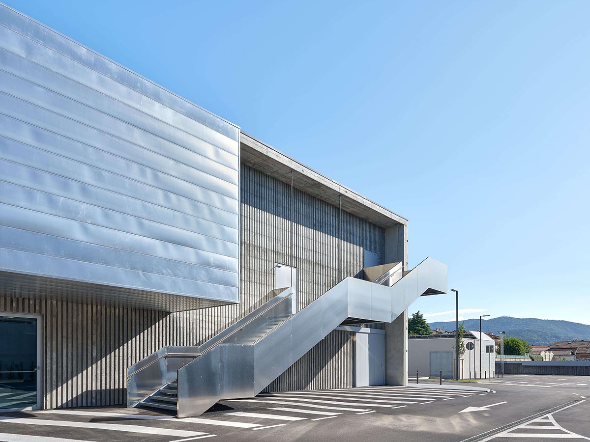 Teatro Borsoni theater is wrapped by façades that feature 3D-punctuated concrete blocks in Italy