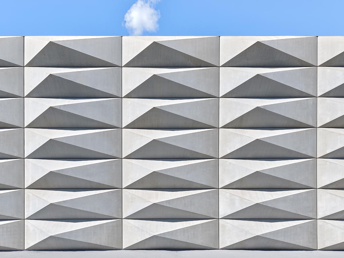 Teatro Borsoni theater is wrapped by façades that feature 3D-punctuated concrete blocks in Italy