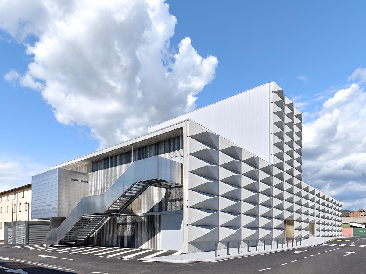 Teatro Borsoni theater is wrapped by façades that feature 3D-punctuated concrete blocks in Italy