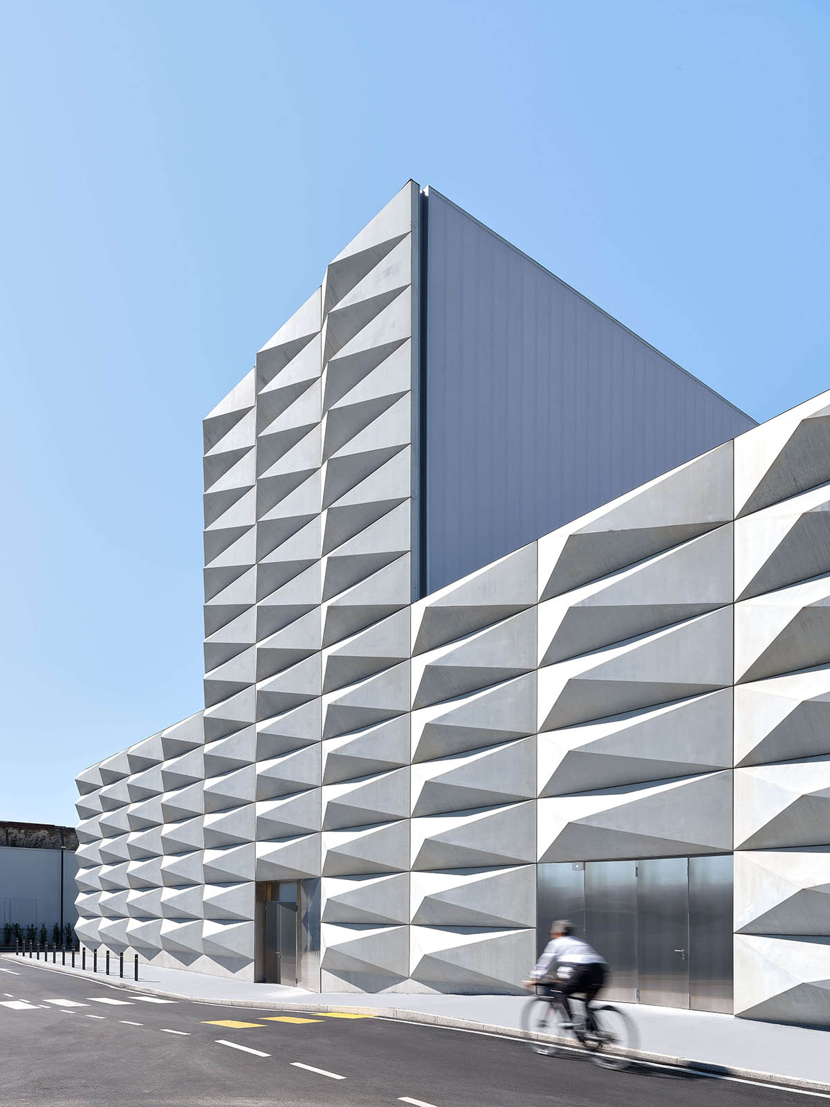 Teatro Borsoni theater is wrapped by façades that feature 3D-punctuated concrete blocks in Italy