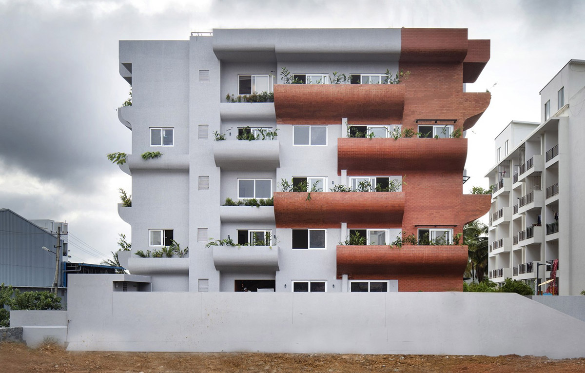 Fluid balconies for this housing help plants to grow comfortably designed by The Purple Ink Studio