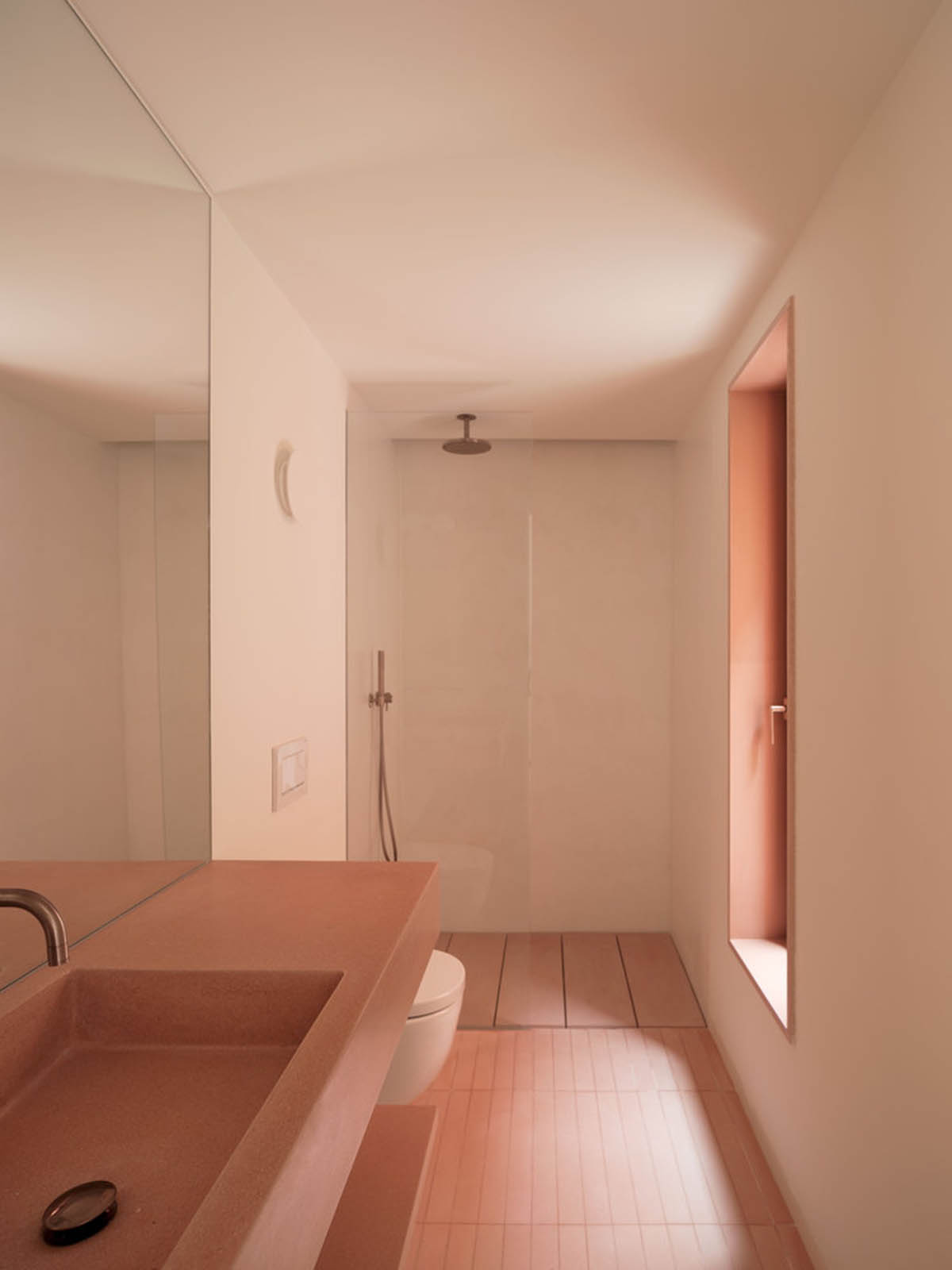 Large openings and reddish-colored façades mark this holiday home by Isla Architects in a rustic land