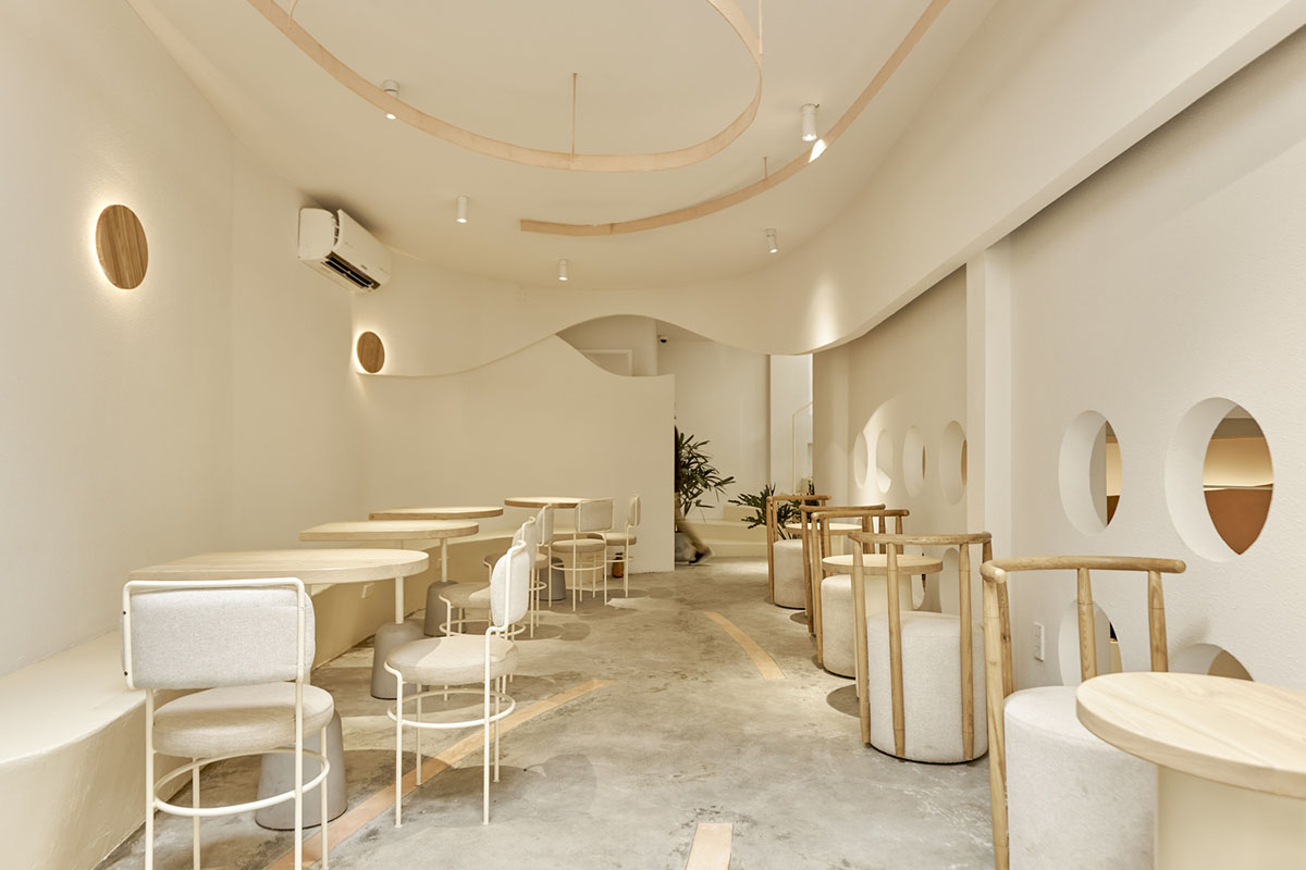 September Cafe is designed to look like a bird's nest with curved steel stripes in Vietnam