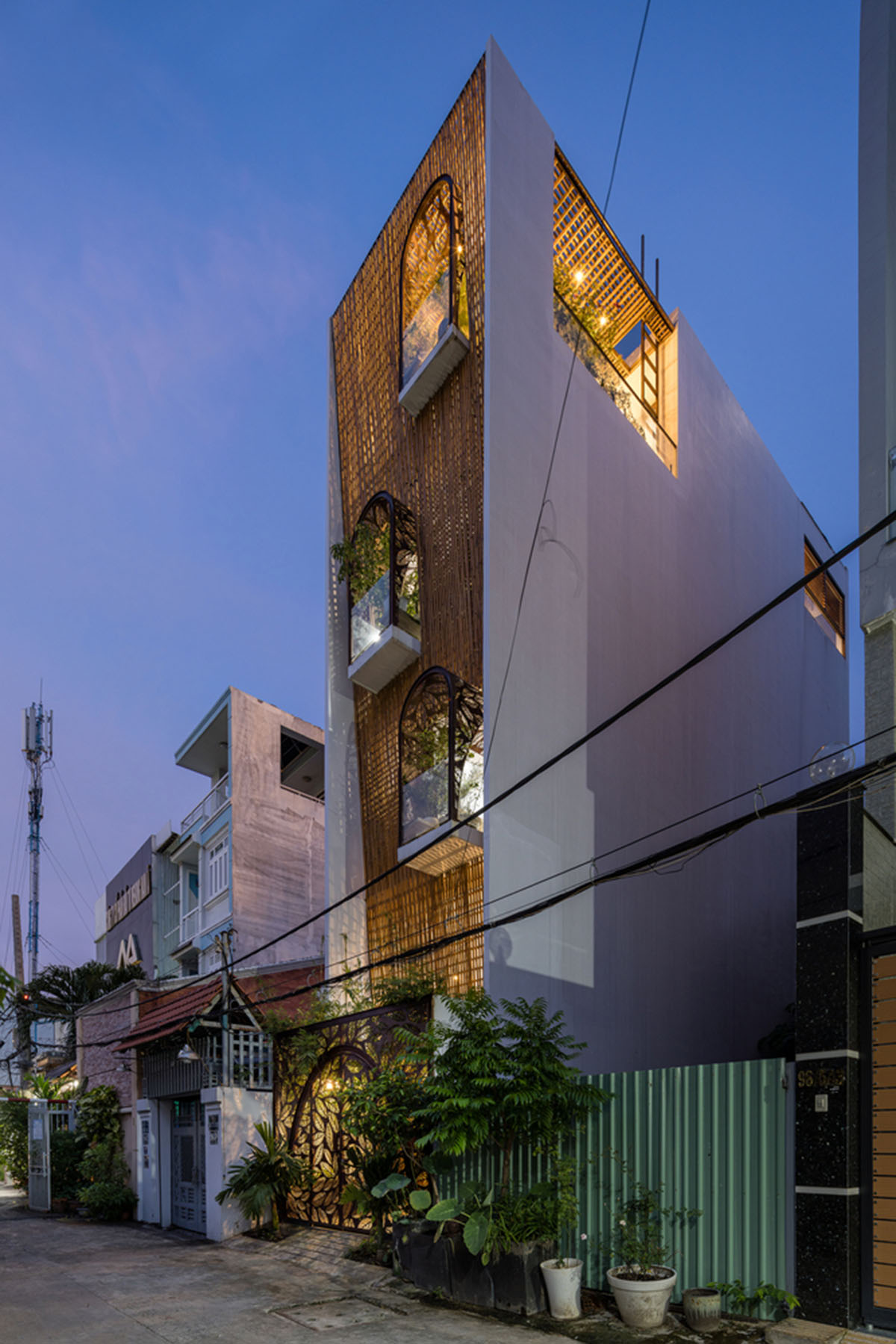 This Vietnamese narrow house by atelier NgNg is clad by woven bamboo ...