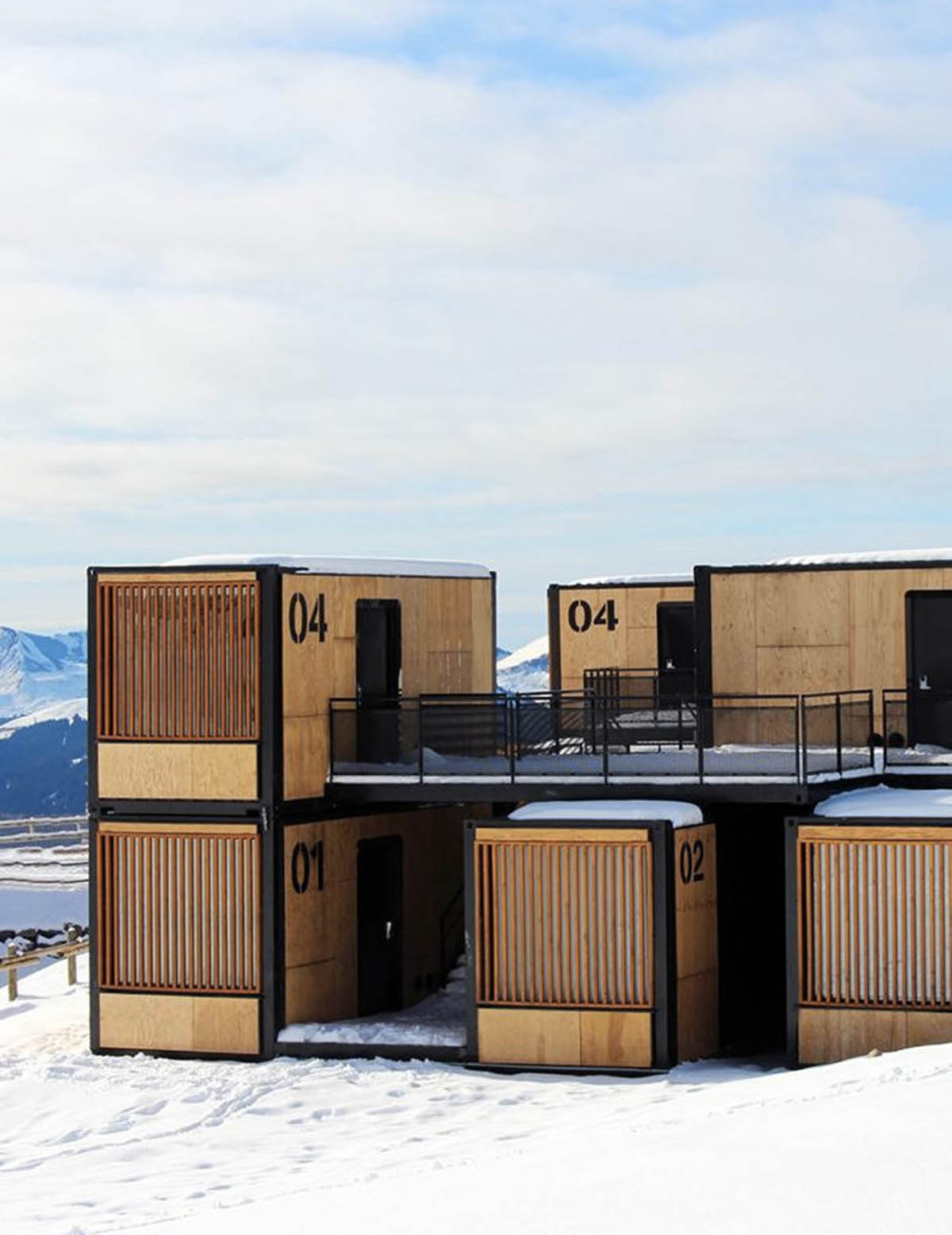 Real wooden shipping containers provide nomadic accommodation designed by Ora Ito