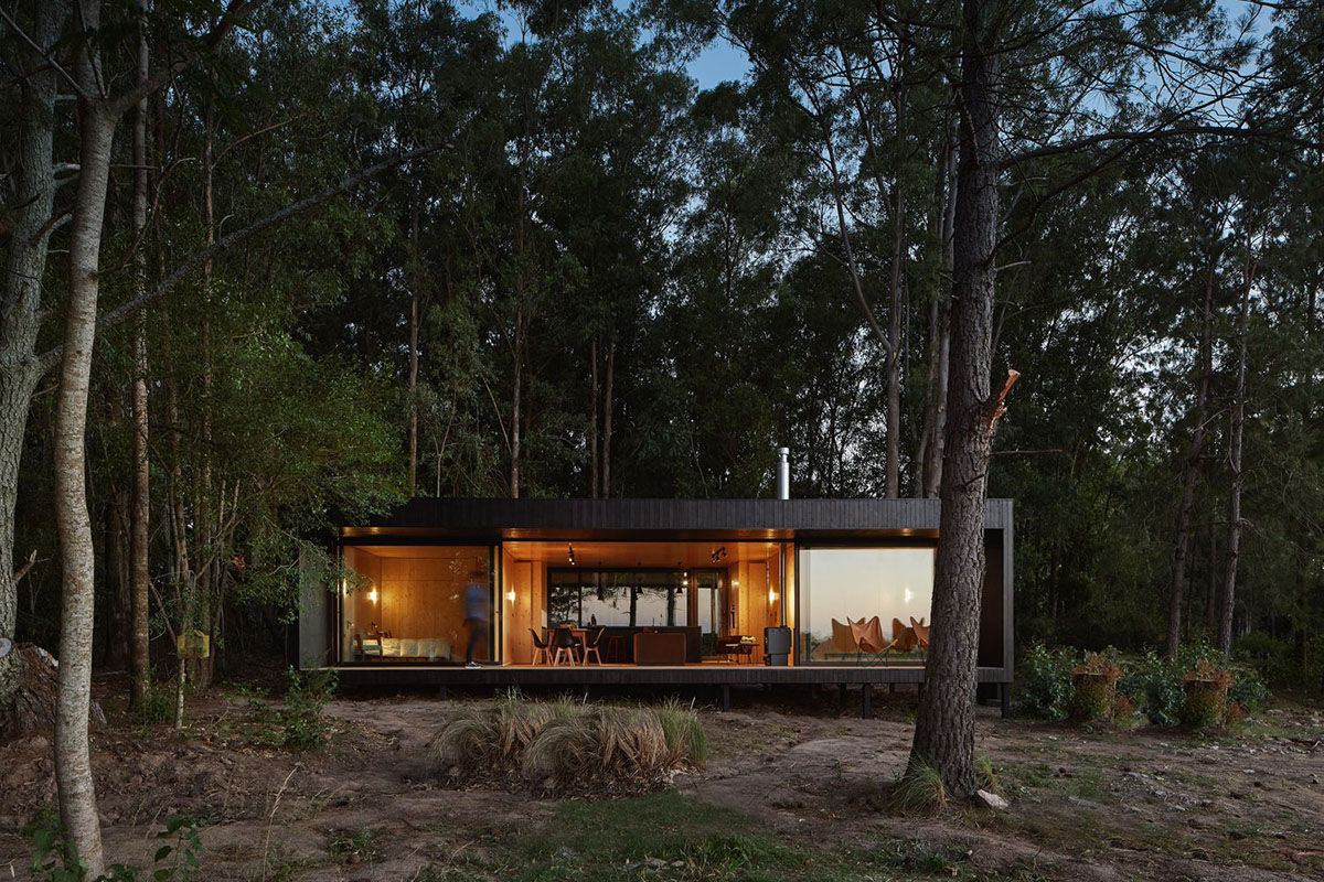 Black wooden cabin by iHouse estudio is an off-grid escape home in Uruguayan native forest