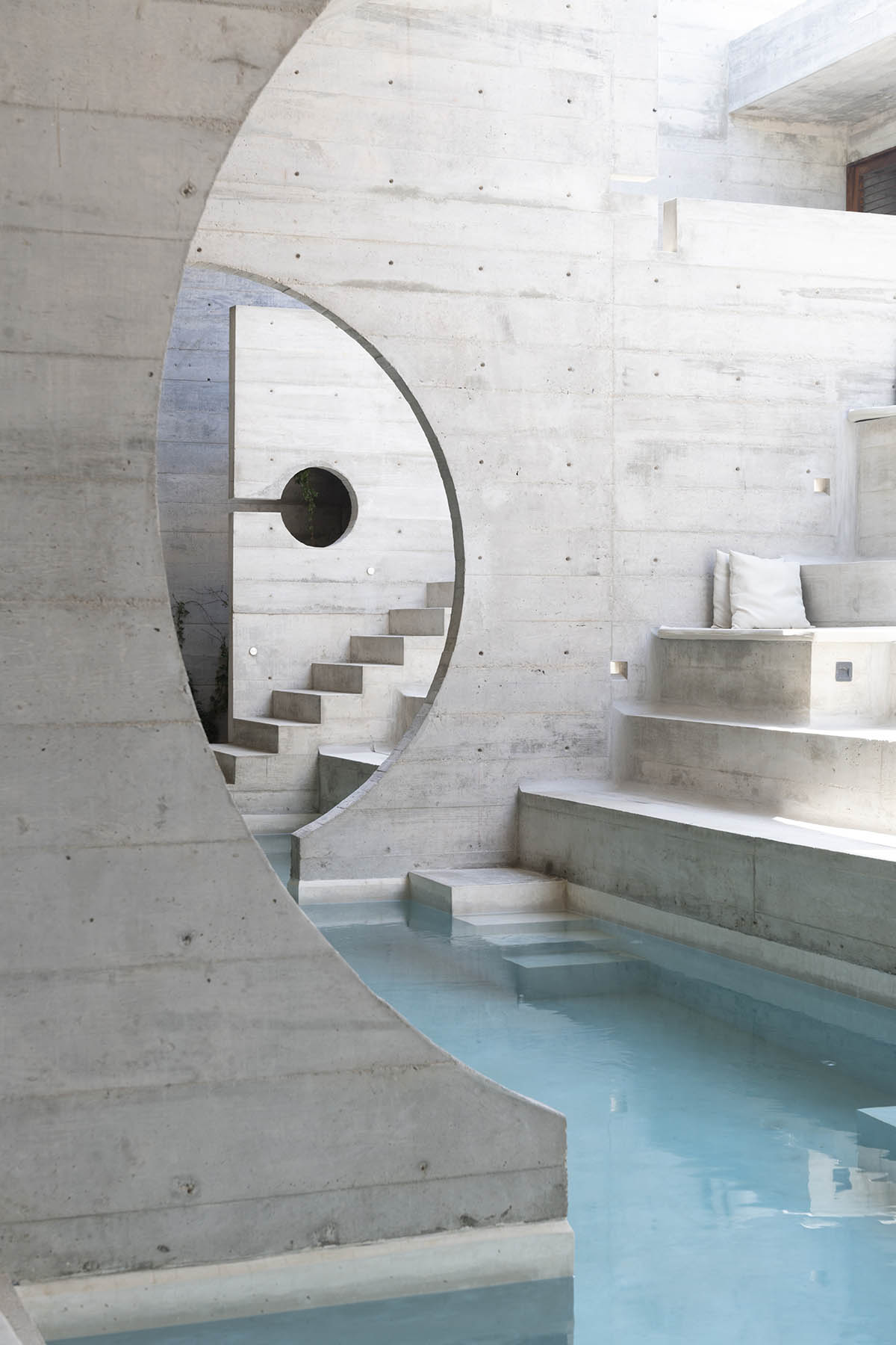 Casa TO by Ludwig Godefroy features an island of stairs and vaulted volumes to create discreet oasis