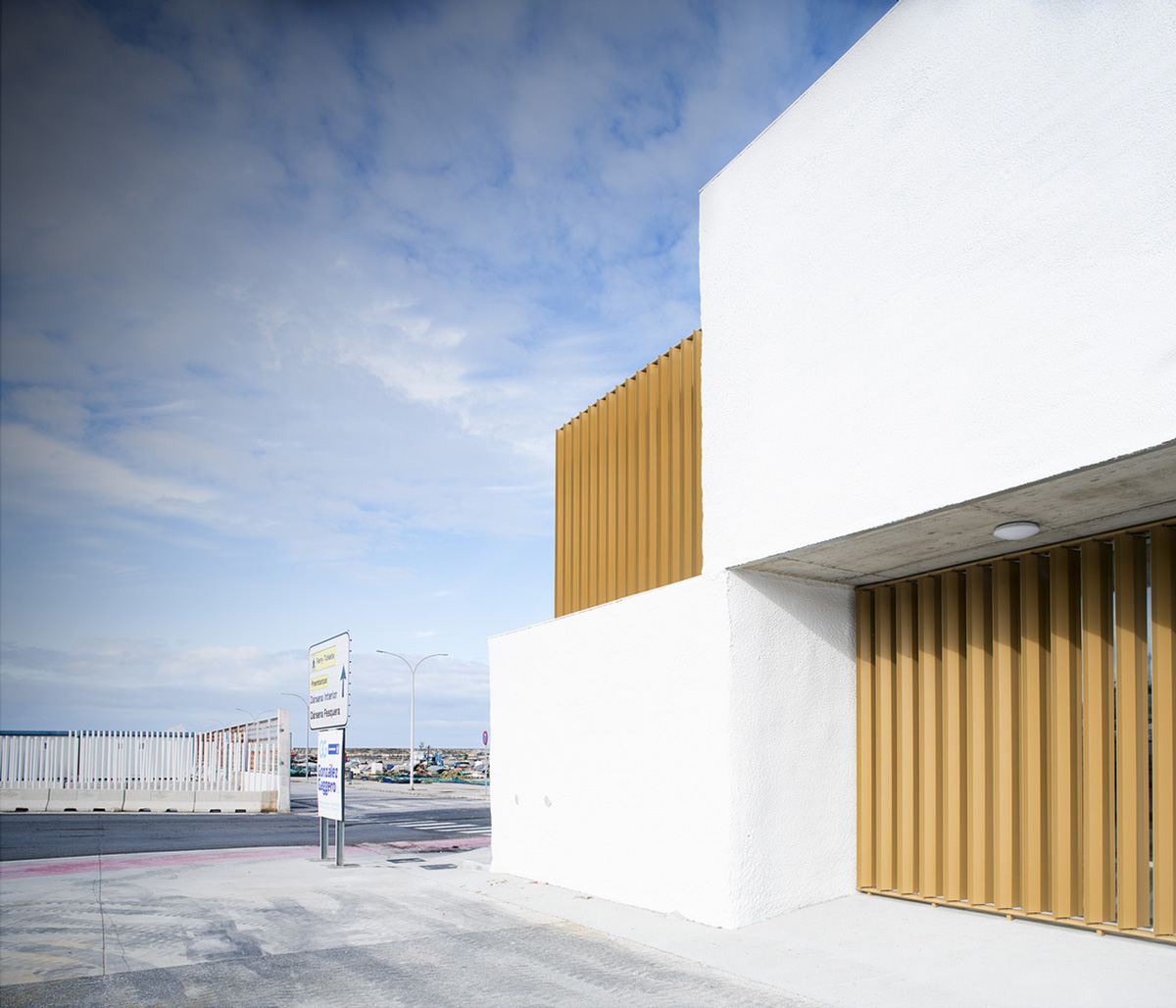 White cubic volumes combined with inward system of patios to create zero-energy Port Operations HQ