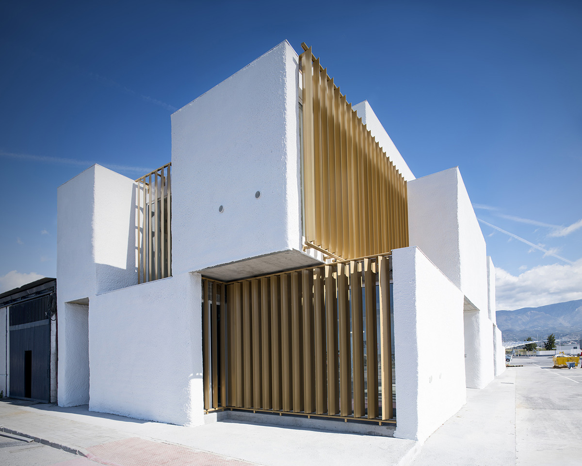 White cubic volumes combined with inward system of patios to create zero-energy Port Operations HQ