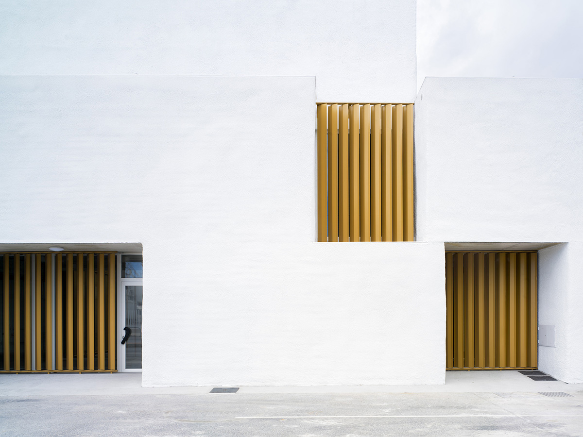 White cubic volumes combined with inward system of patios to create zero-energy Port Operations HQ