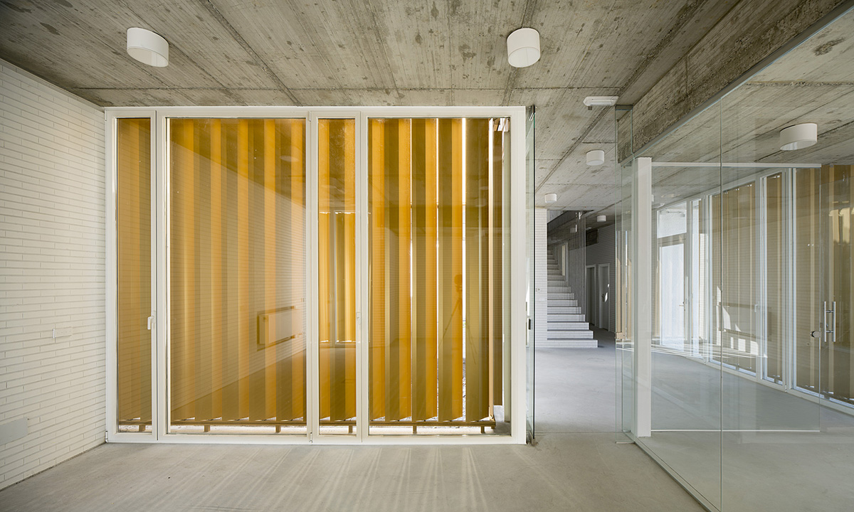 White cubic volumes combined with inward system of patios to create zero-energy Port Operations HQ