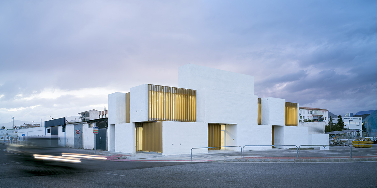 White cubic volumes combined with inward system of patios to create zero-energy Port Operations HQ