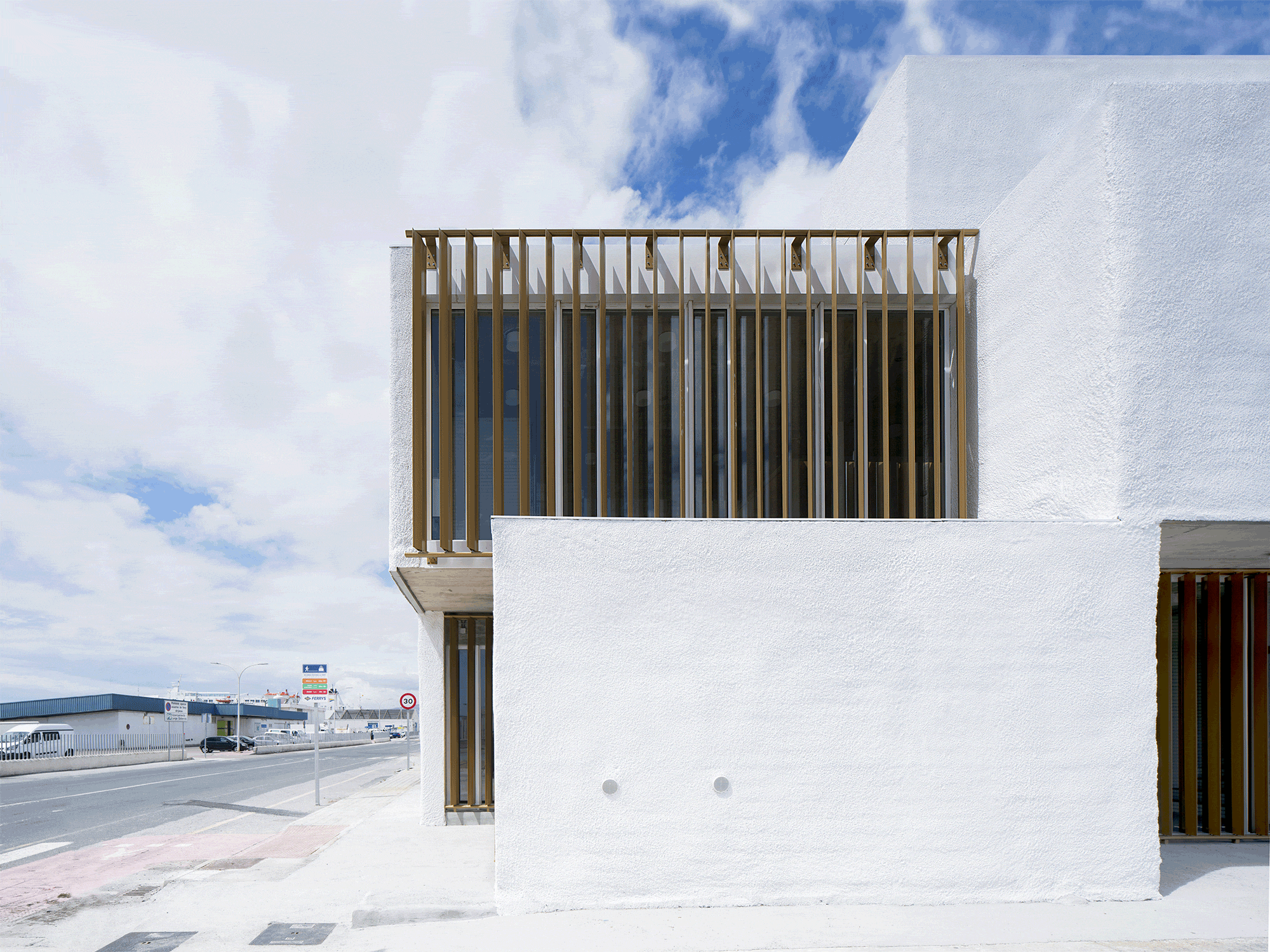 White cubic volumes combined with inward system of patios to create zero-energy Port Operations HQ