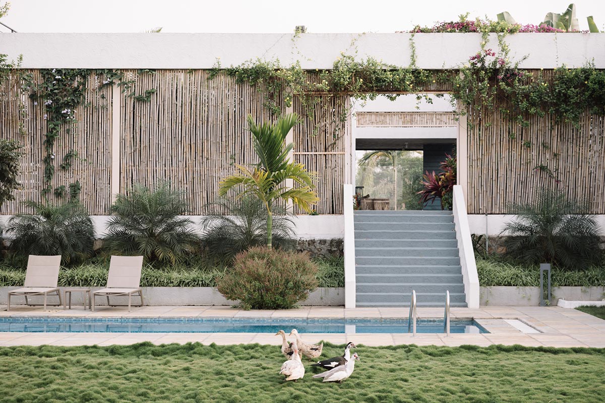 Weekend home is clad in bamboo screens that create a rustic appearance on the outskirts of Pune