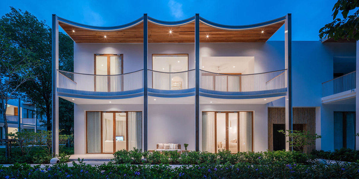 onion combines white concave and convex walls with colorful surfaces for beach resort in Thailand