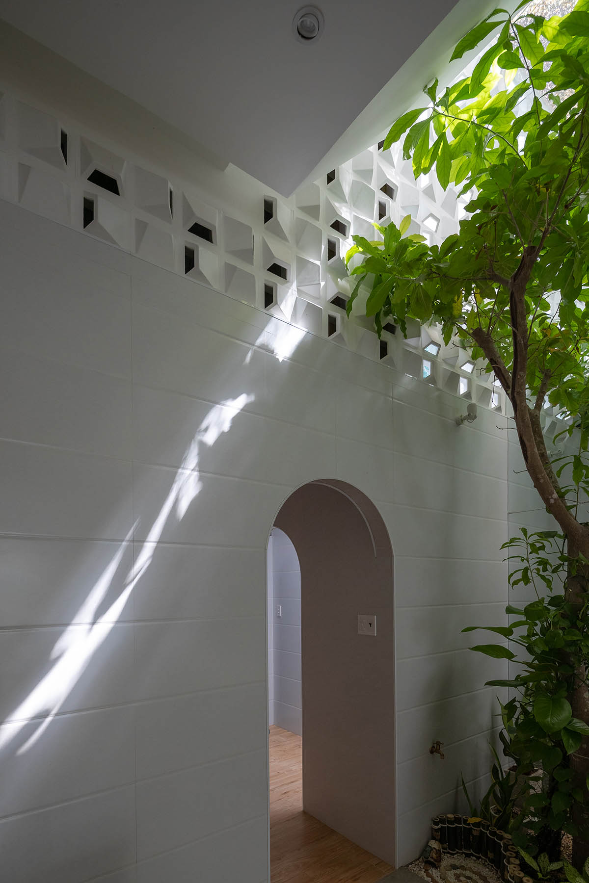 CoCo House, inspired by animated film, is clad in glass brick façade with wavy patterns in Vietnam