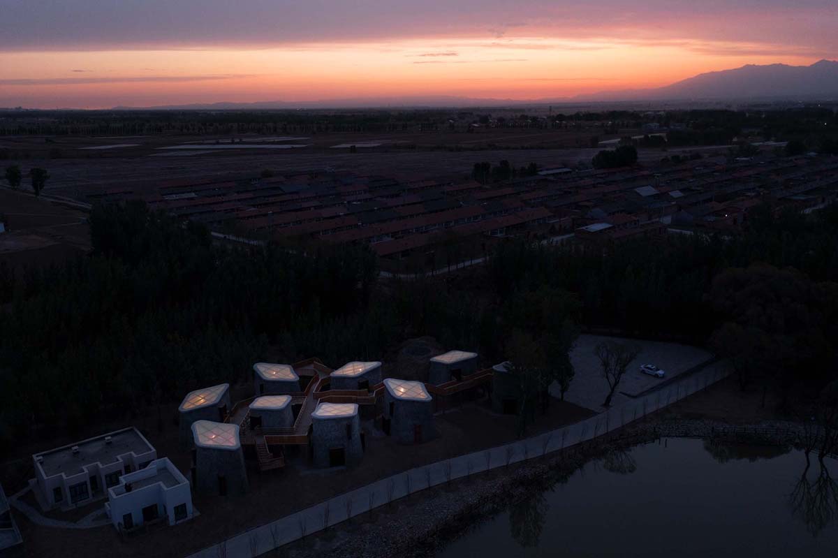 Hyperbolic vertical grottos are activated by a network of floating wooden bridges in China