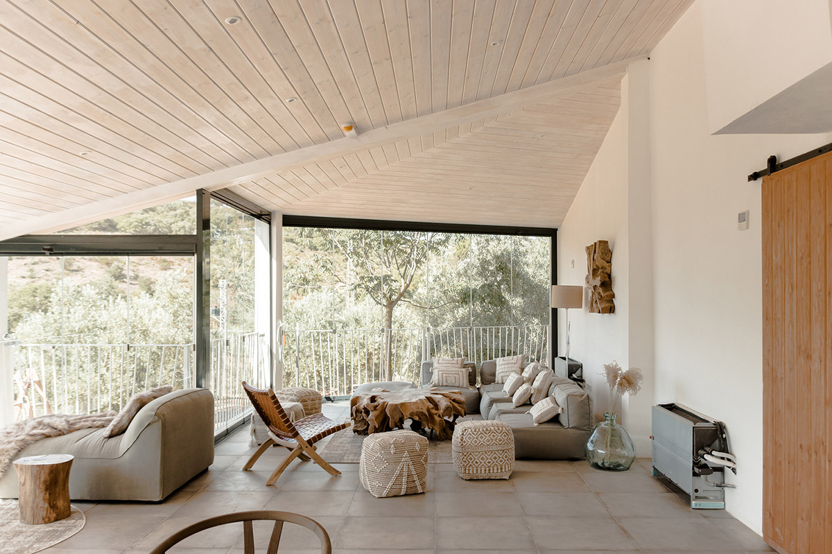 GANA Arquitectura adds rooms to old storehouse with division of facade among olive trees in Spain