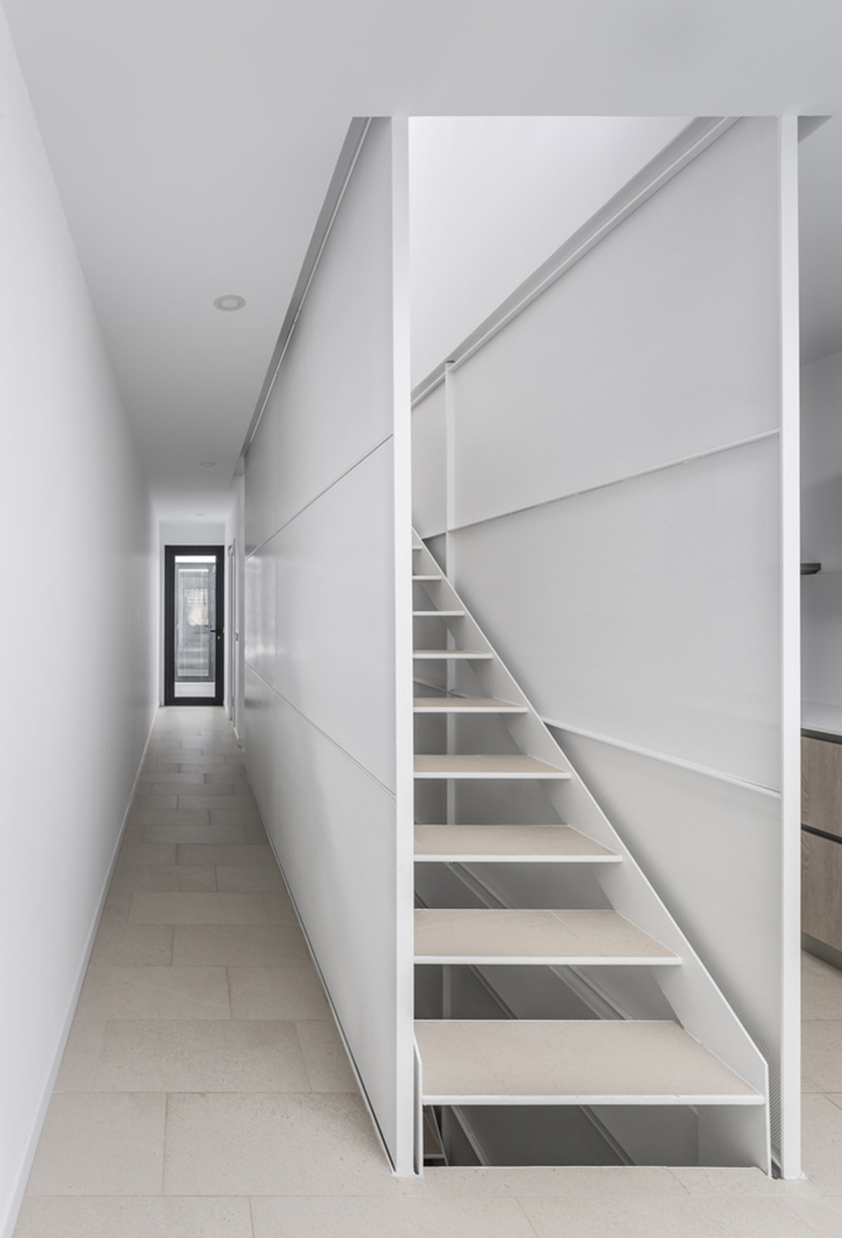 Viraje arquitectura creates perforated façade for elongated family house to play with natural light