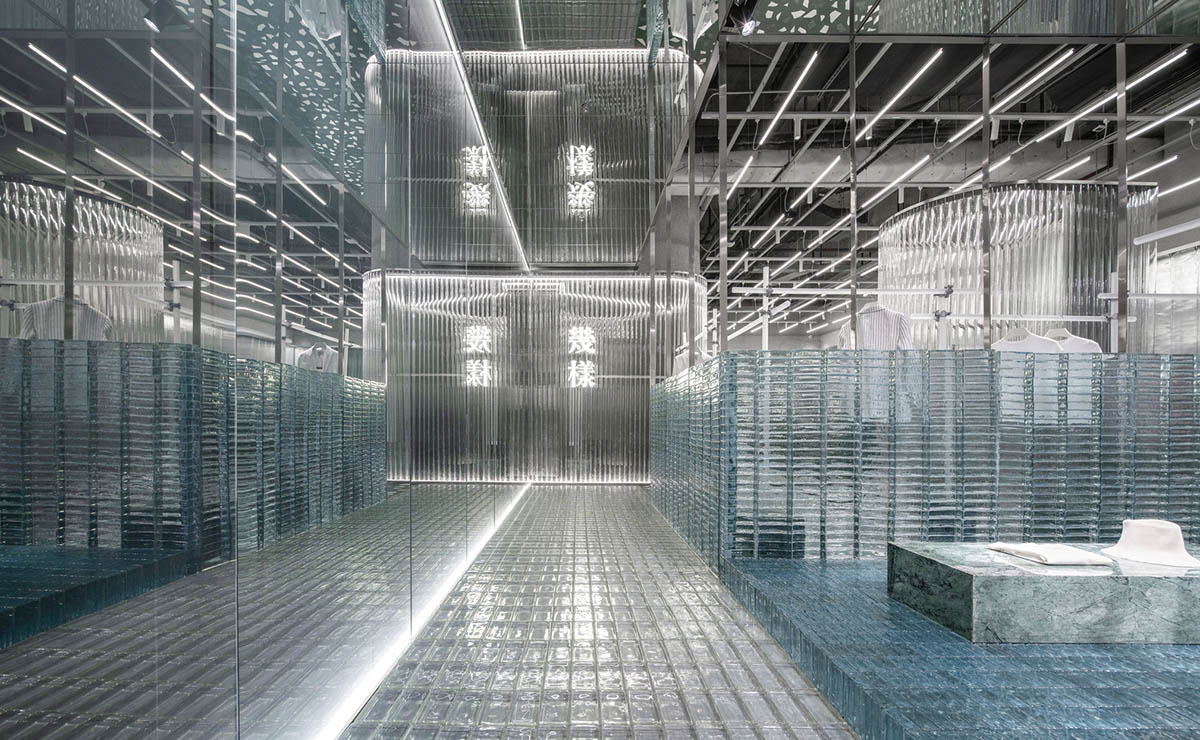 Studio 10 designs fashion store combining different hues of green color with reflective surfaces