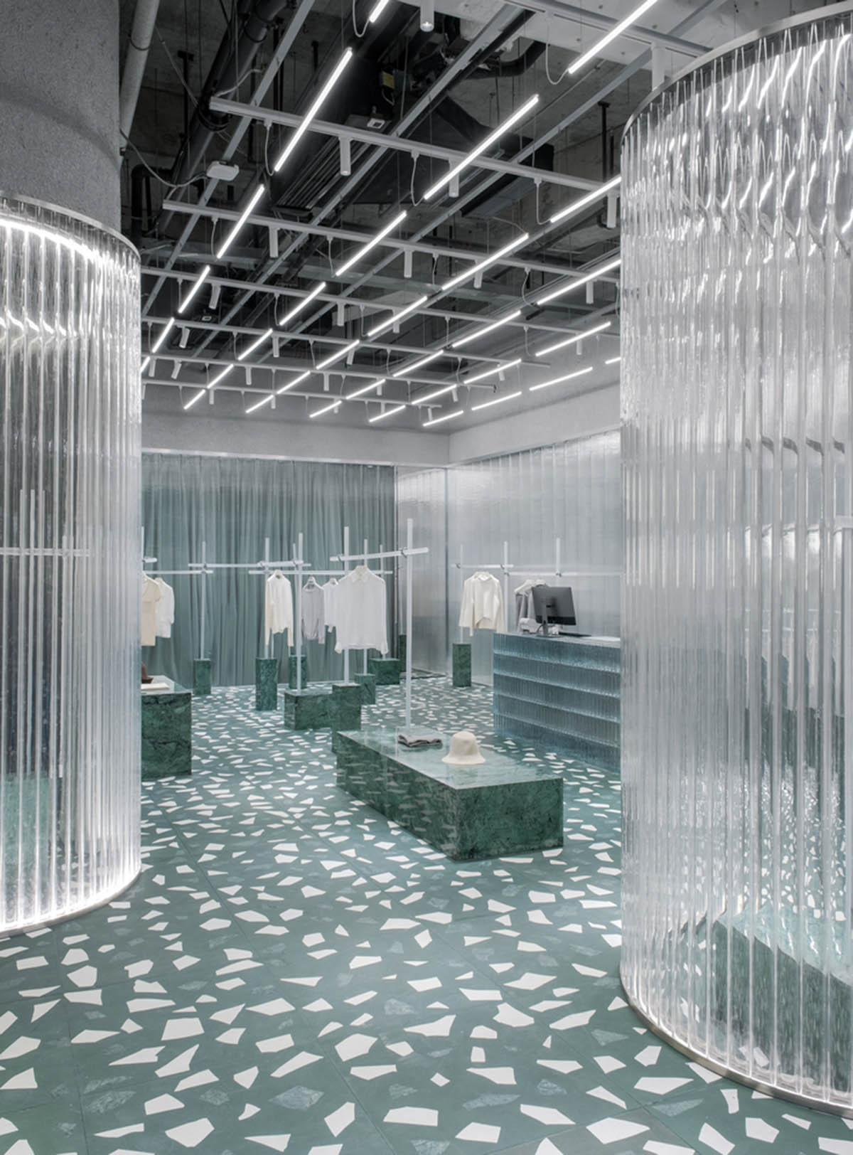 Studio 10 designs fashion store combining different hues of green color with reflective surfaces