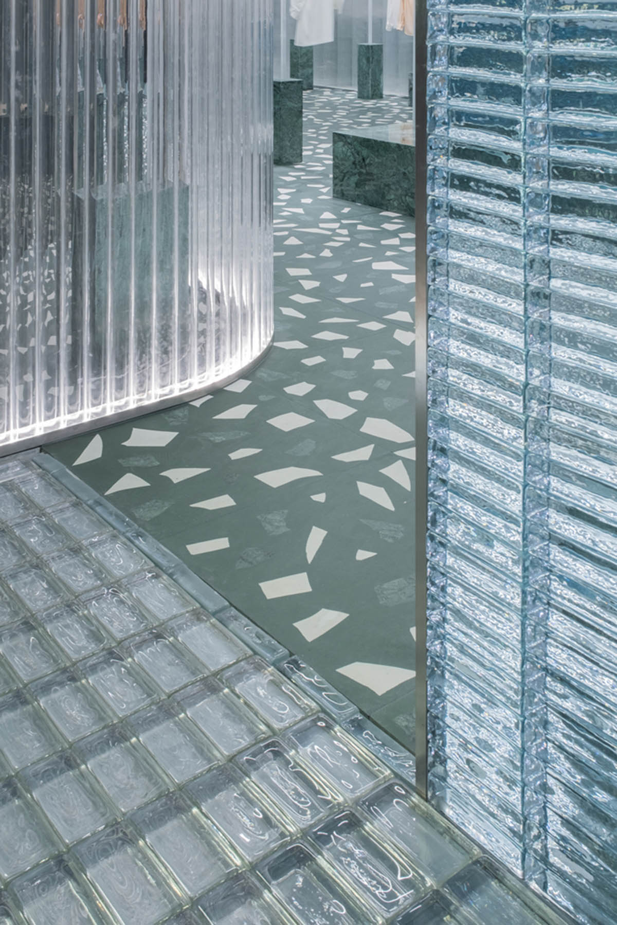 Studio 10 designs fashion store combining different hues of green color with reflective surfaces