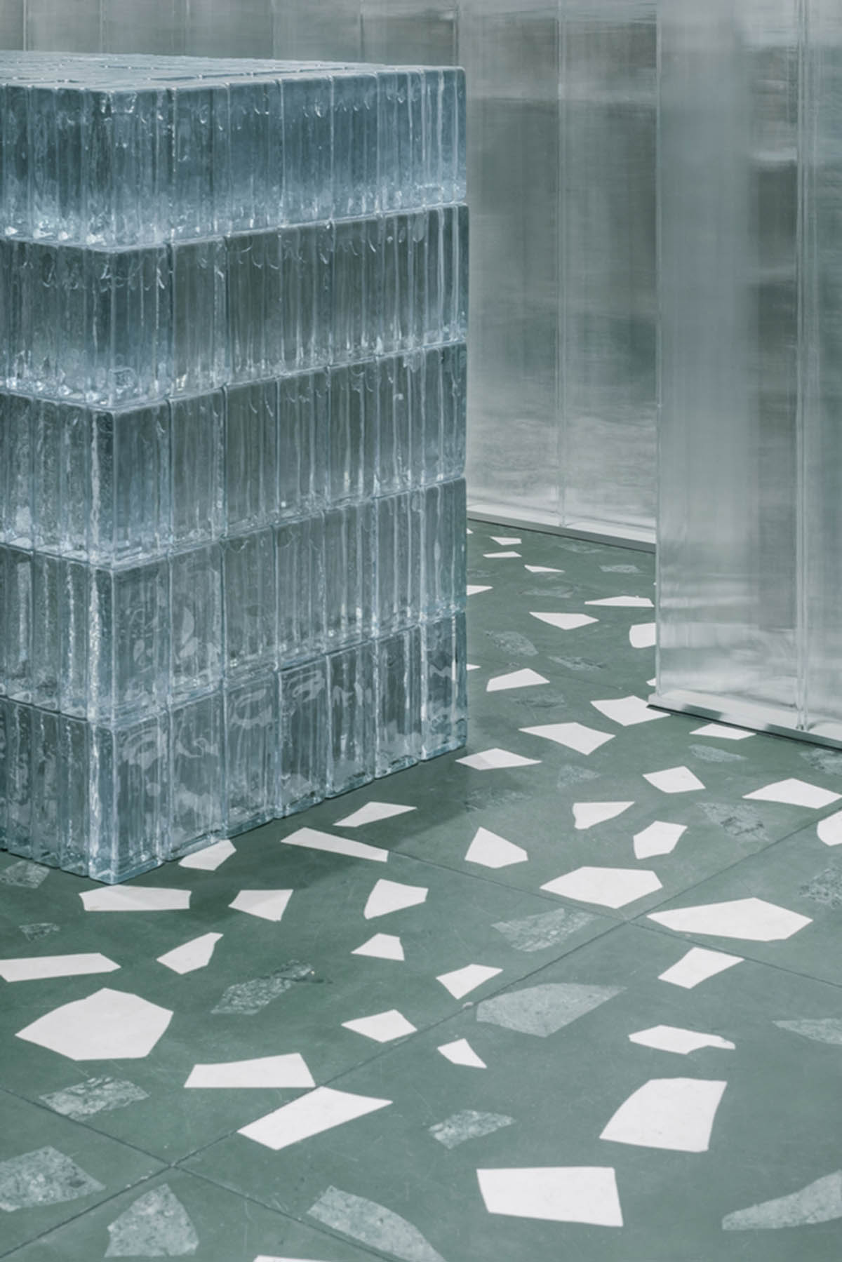 Studio 10 designs fashion store combining different hues of green color with reflective surfaces