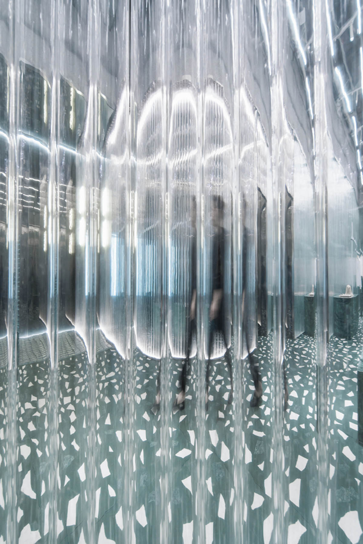 Studio 10 designs fashion store combining different hues of green color with reflective surfaces