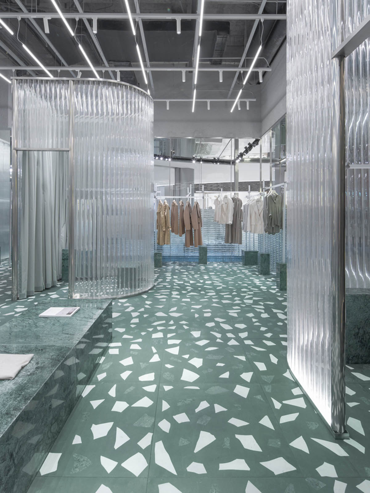 Studio 10 designs fashion store combining different hues of green color with reflective surfaces