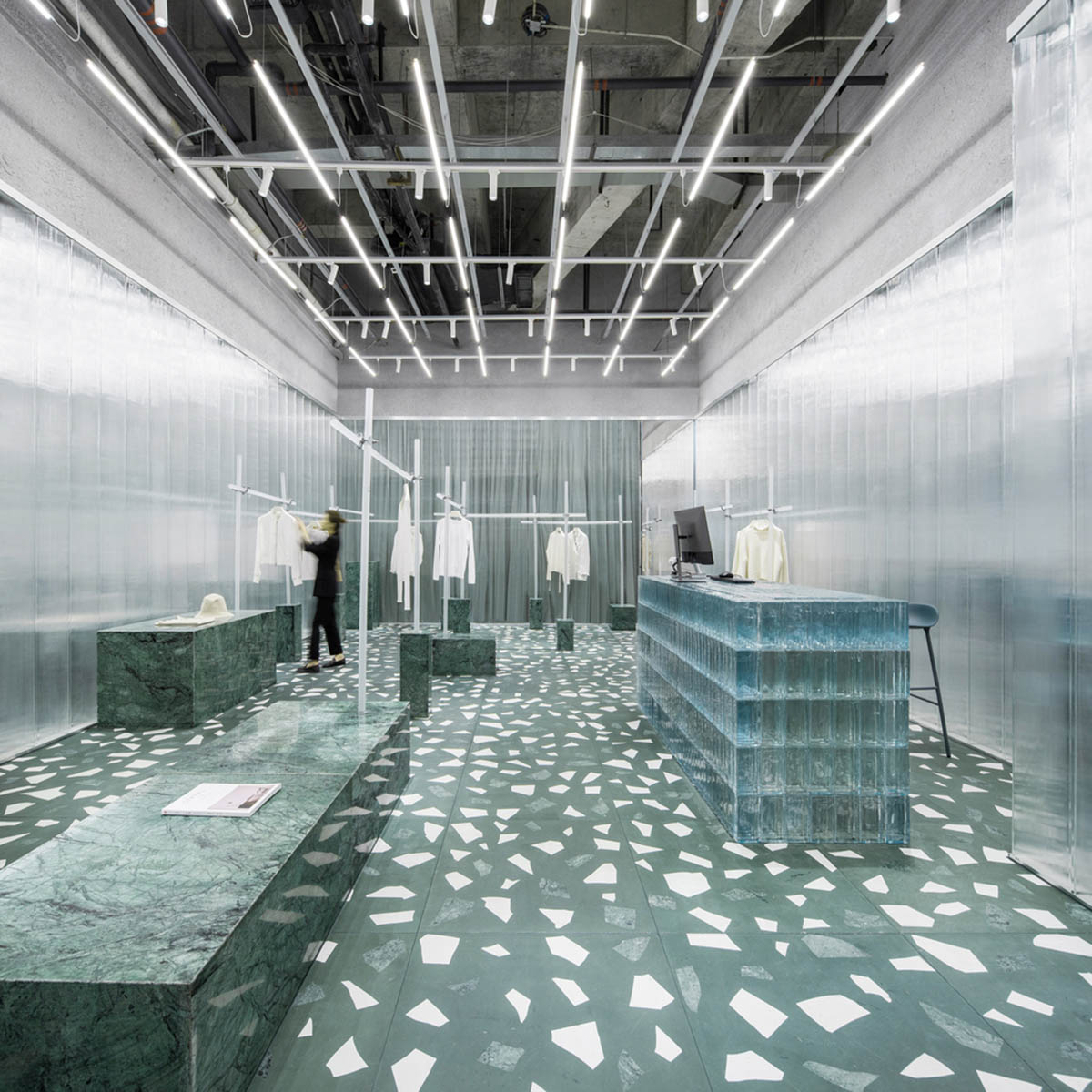 Studio 10 designs fashion store combining different hues of green color with reflective surfaces