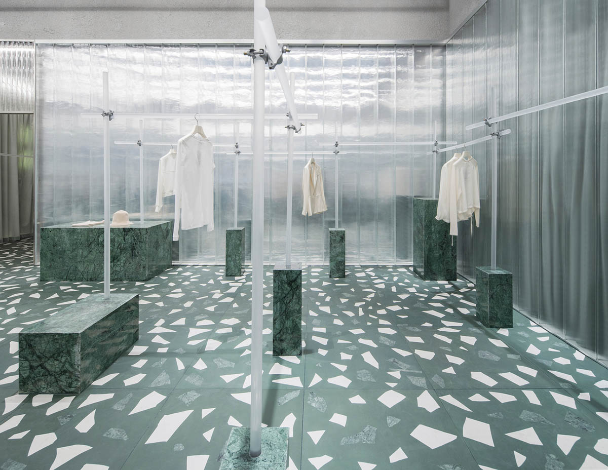 Studio 10 designs fashion store combining different hues of green color with reflective surfaces