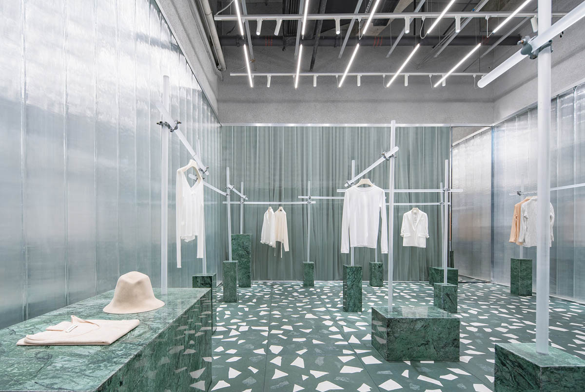 Studio 10 designs fashion store combining different hues of green color with reflective surfaces