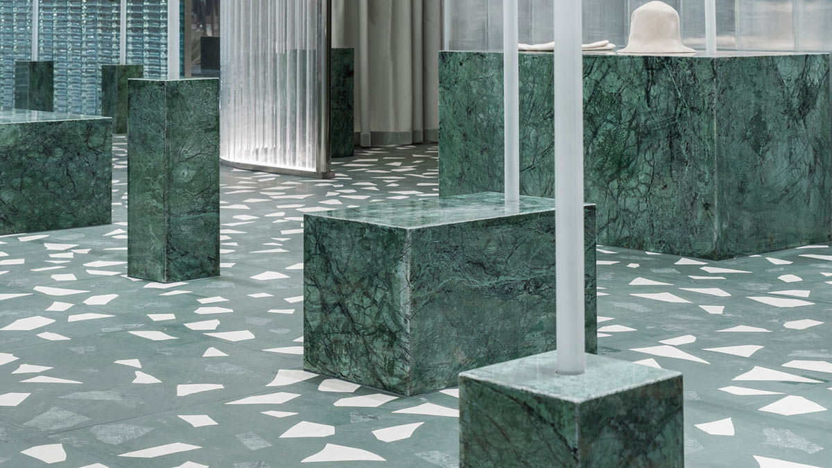 Studio 10 designs fashion store combining different hues of green color with reflective surfaces