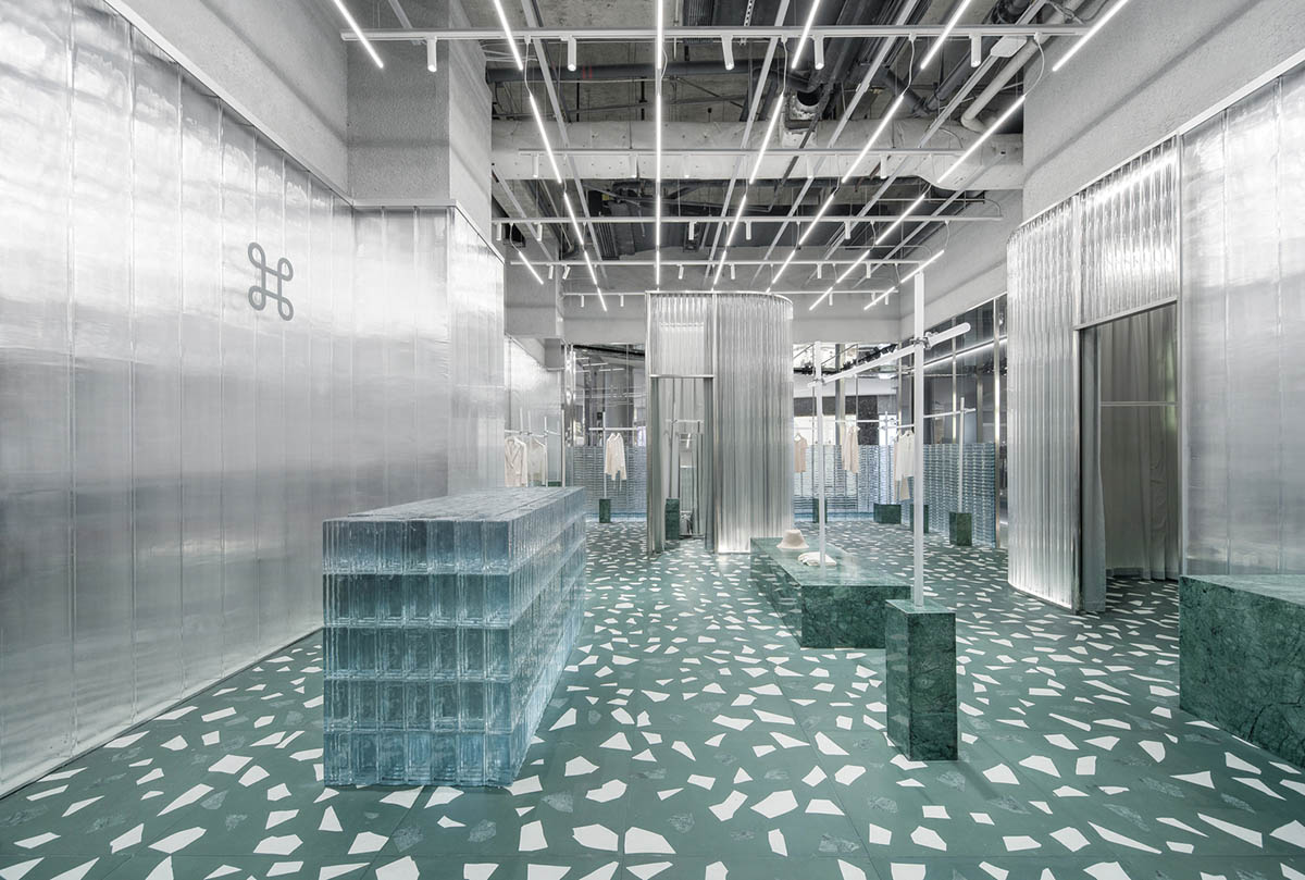 Studio 10 designs fashion store combining different hues of green color with reflective surfaces