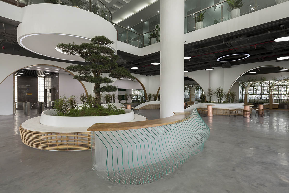 Copper-colored staircase and mini-bamboo trees provide tropical interior for this office in Vietnam