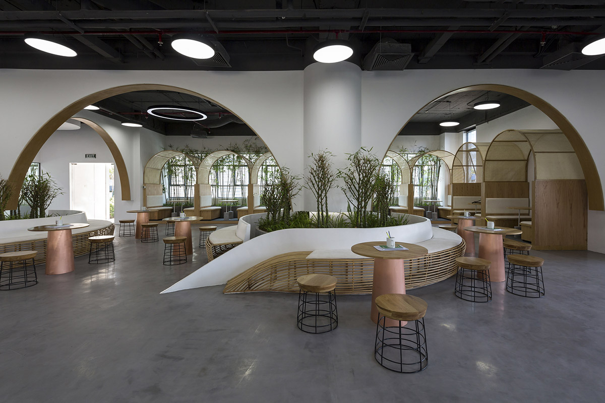 Copper-colored staircase and mini-bamboo trees provide tropical interior for this office in Vietnam